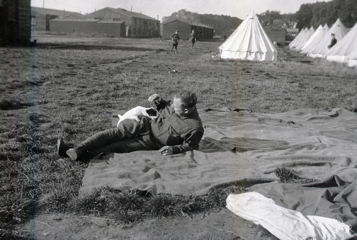 Soldier at Rest with Camp Dog, WWI-Era Military Encampment