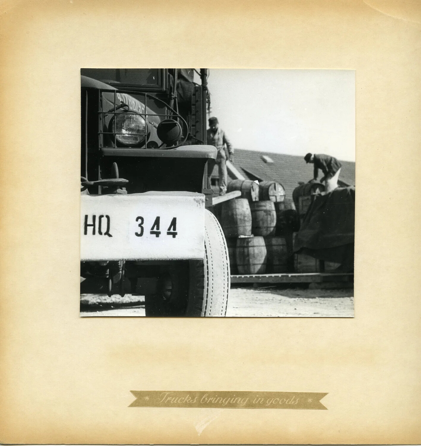 "Trucks Bringing in Goods" — Studebaker Cargo Truck and Barrel Unloading at a Germany Supply Depot