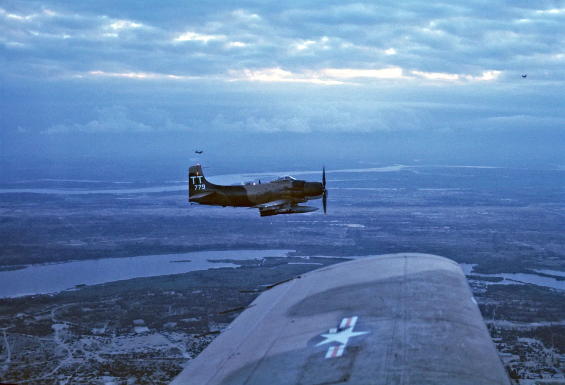 USAF A-1 Skyraider "TT 779" in Flight Over Vietnamese Delta Terrain, Dusk