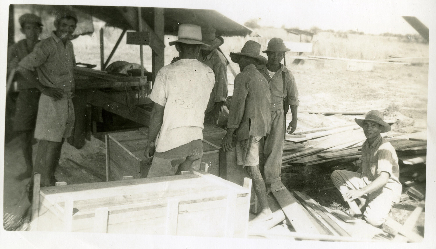 Civilian Laborers Building Wooden Crates at an Okinawa Work Yard, WWII Era