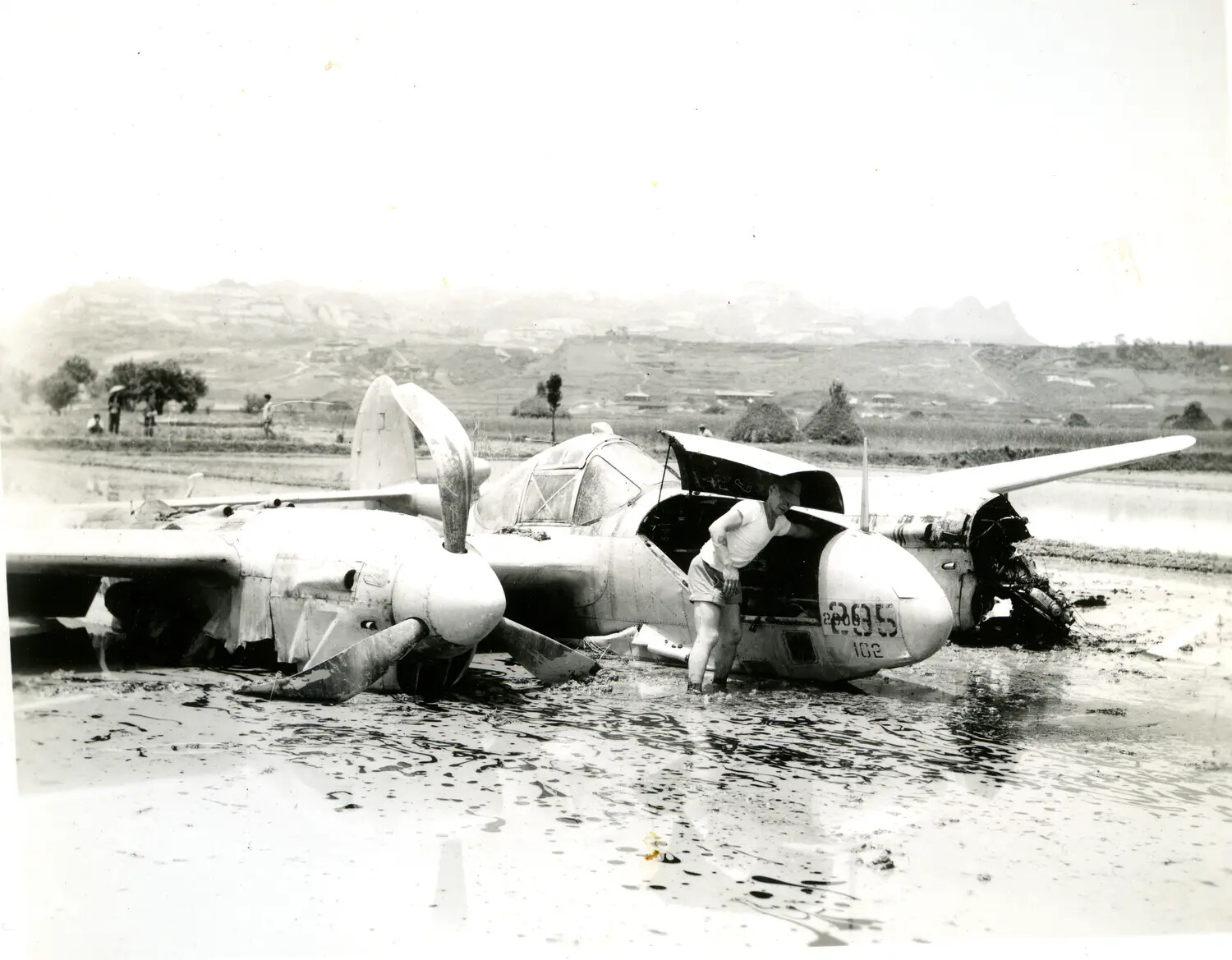 Crash-Landed Twin-Engine Aircraft in Flooded Rice Paddy, China-Burma-India Theater, WWII