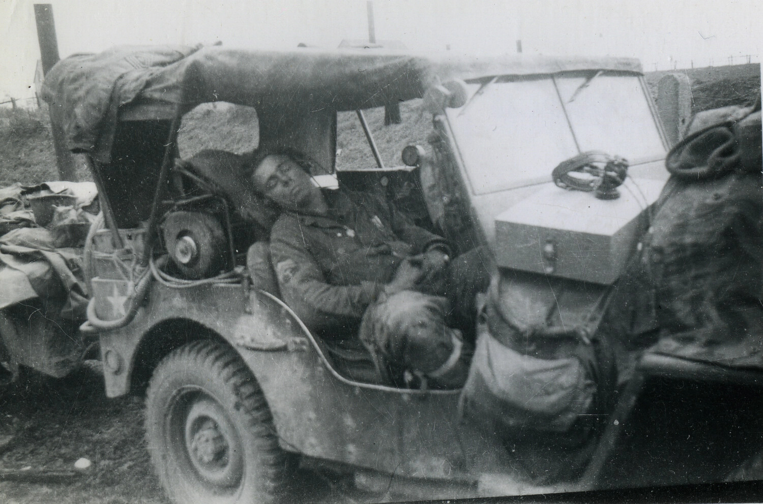 Exhausted 101st Airborne Soldier Asleep in Loaded Jeep, European Theater, WWII