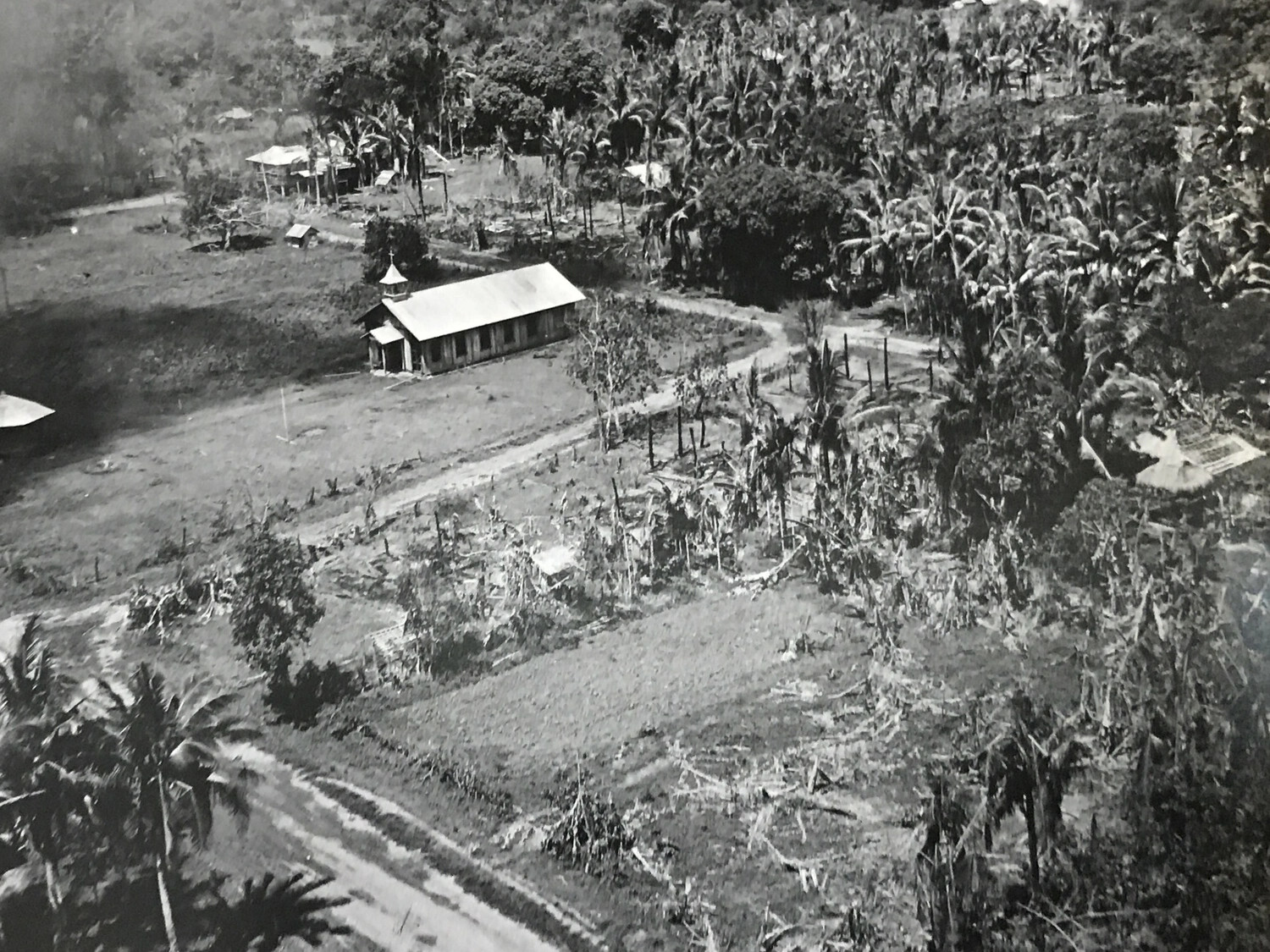Aerial View of Intact Rural Chapel Amid War-Damaged Vegetation, Luzon, Philippines