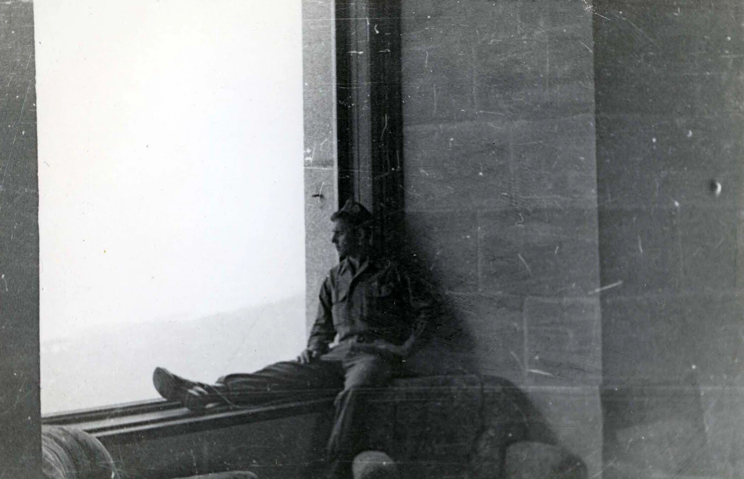 American Soldier Seated in Stone Window Embrasure Overlooking Landscape, European Theater, WWII