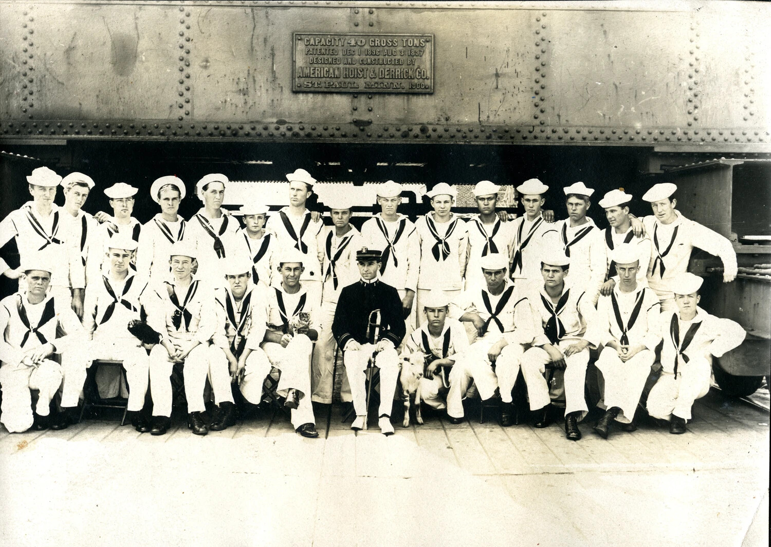 Group Portrait of U.S. Navy Sailors and Bandmaster Beneath a Boat Davit, USS Columbia Album, c. 1900s