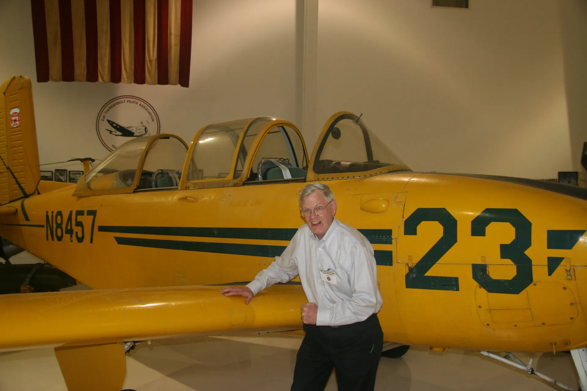 Veteran Posing with Vintage Training Aircraft at Aviation Museum, 2016
