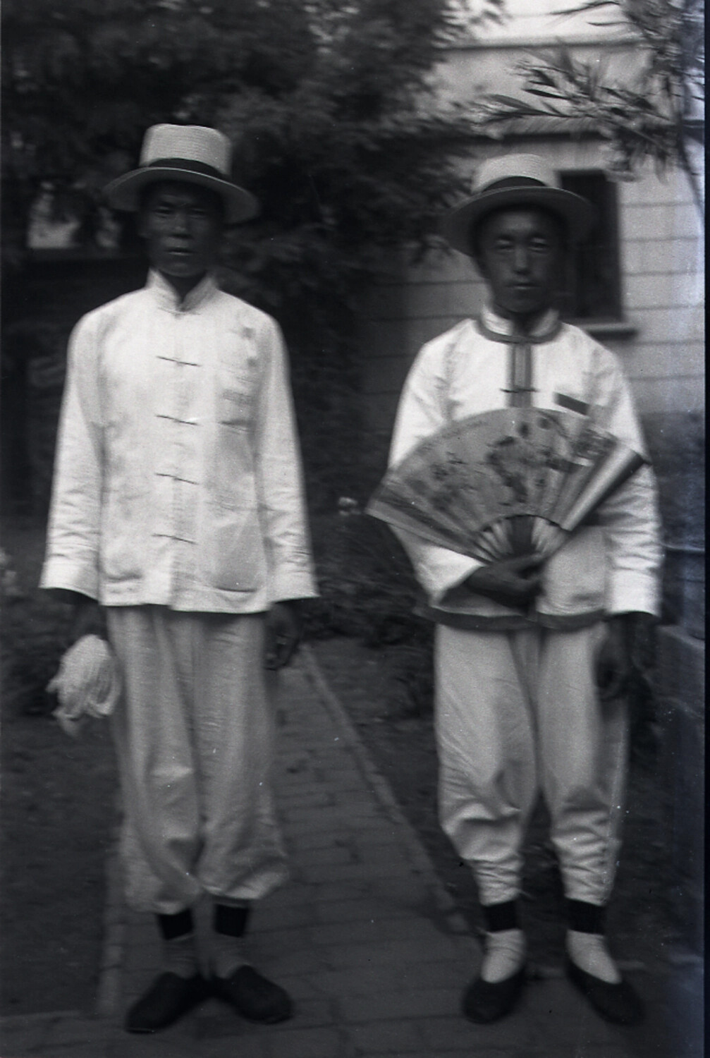 Two Chinese Men in Matching Boater Hats and Tunics, China, 1930s