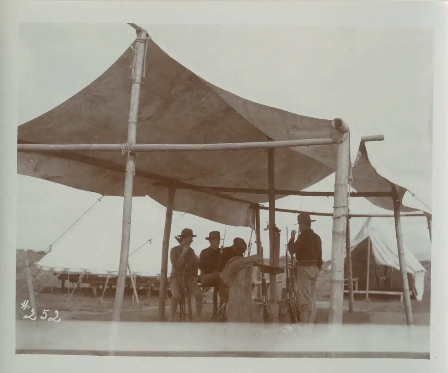 U.S. Army Soldiers Beneath Bamboo-Framed Canvas Shelter, Philippine Encampment, c. 1898-1902