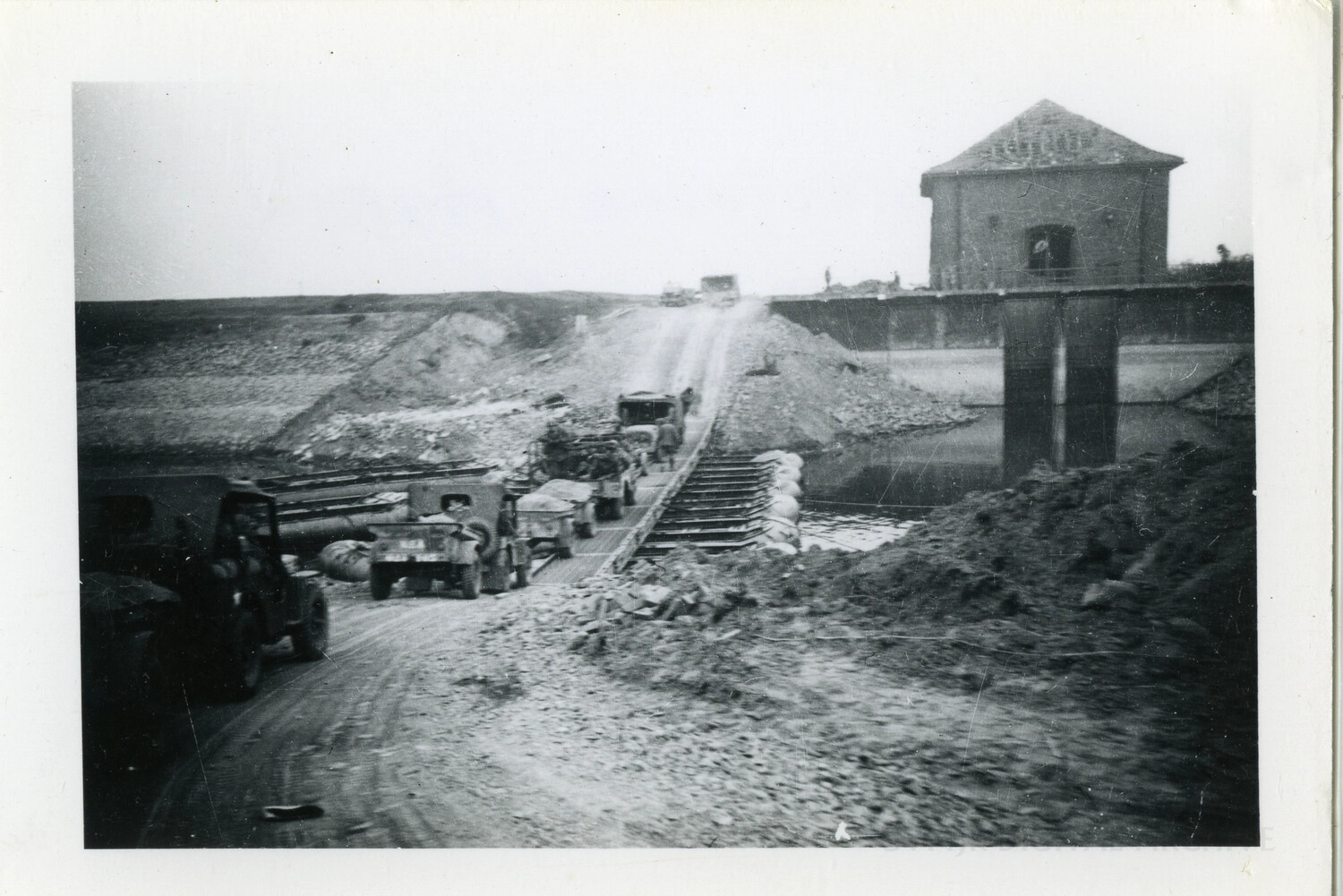 Military Convoy Crossing a Combat Engineer Pontoon Bridge