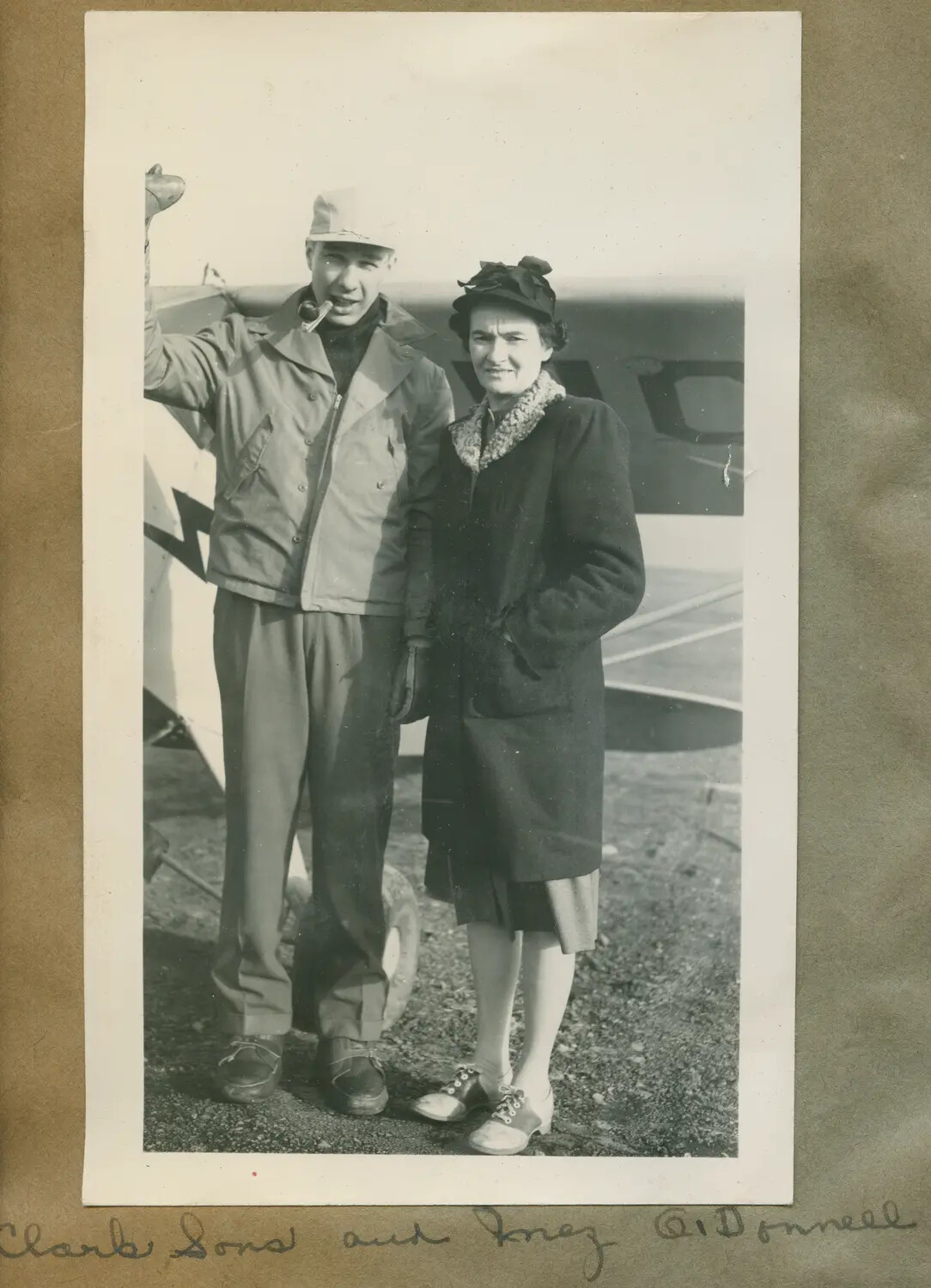 Snapshot of a Man and Woman Beside a Light Civilian Aircraft, with Handwritten Caption