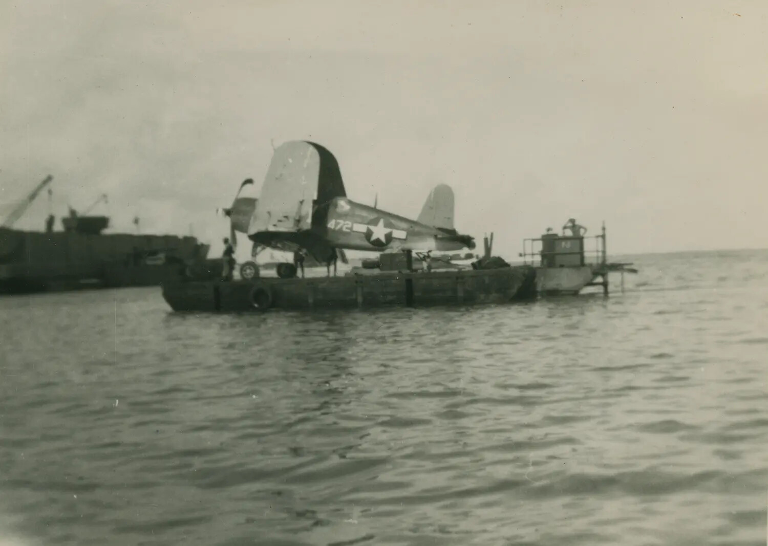 F4U Corsair Fighter Aircraft Loaded on Salvage Barge, Pacific Theater, World War II