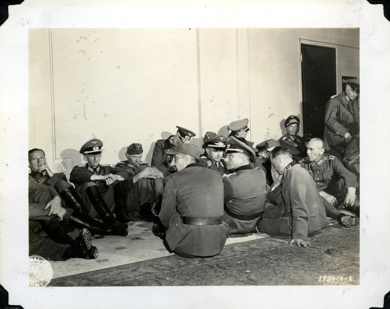U.S. Army Signal Corps Photograph: Captured German Officers Seated Under Guard, WWII European Theater, 1945