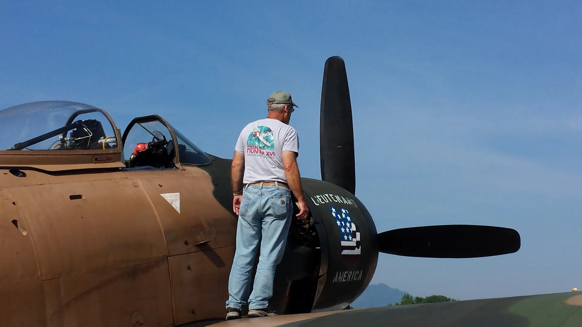 Ground Crew Inspecting Douglas A-1 Skyraider "Lieutenant America" Engine, Wearing "Hun Hunter XVI" Shirt