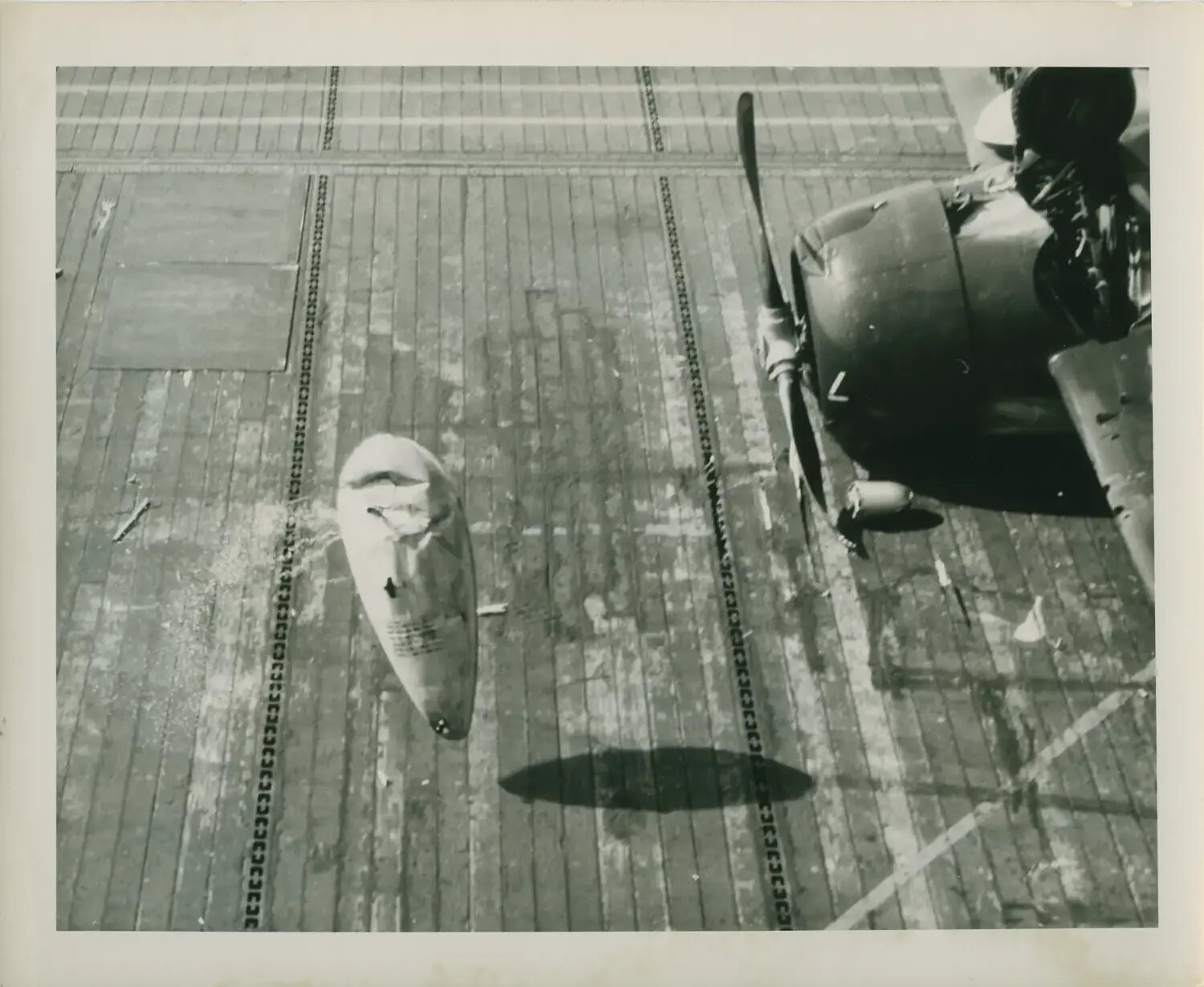 Jettisoned External Fuel Tank on Flight Deck Beside Aircraft, USS Petrof Bay (CVE-80), WWII