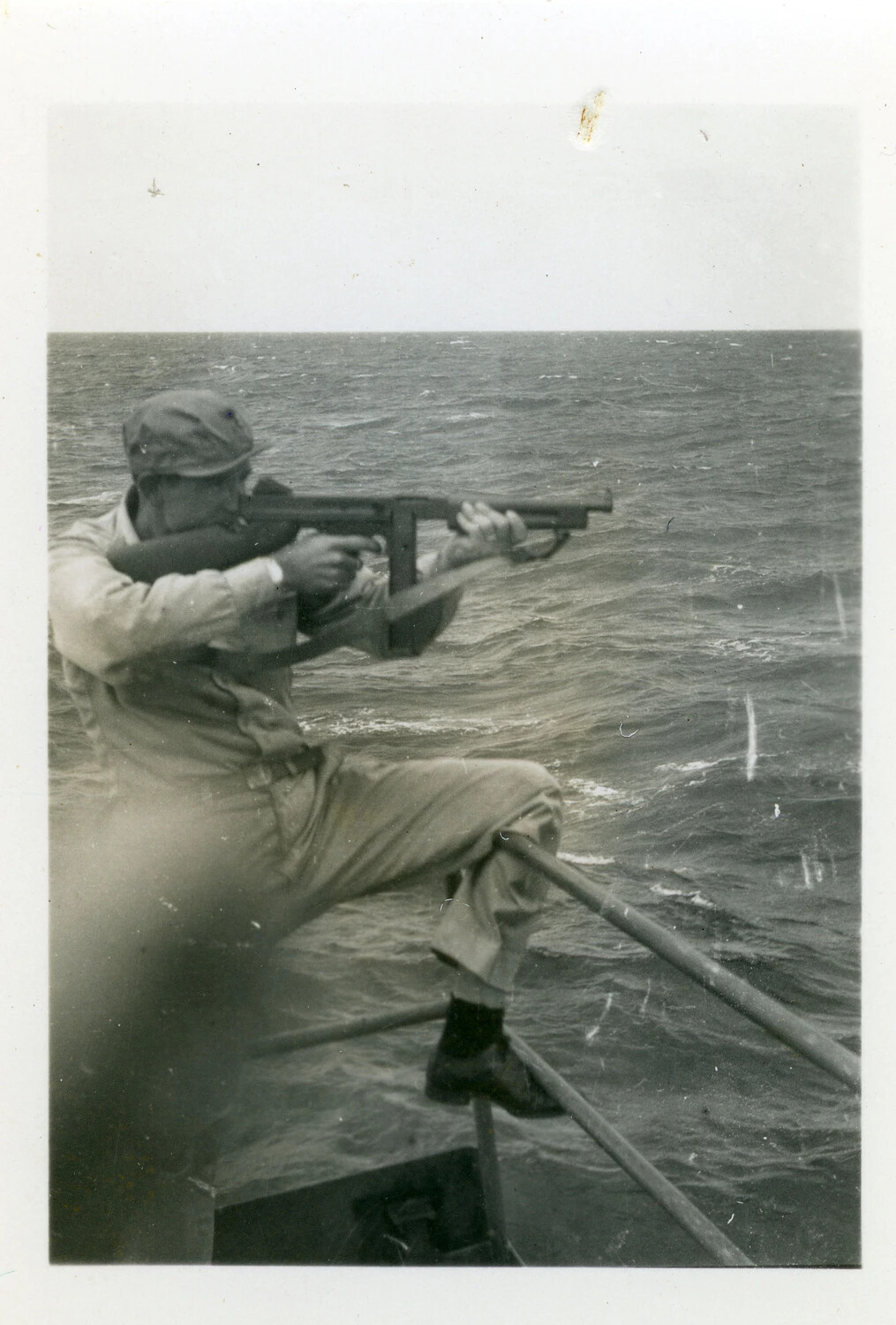 Sailor Firing a Thompson Submachine Gun from Ship's Bow, Pacific Theater, WWII