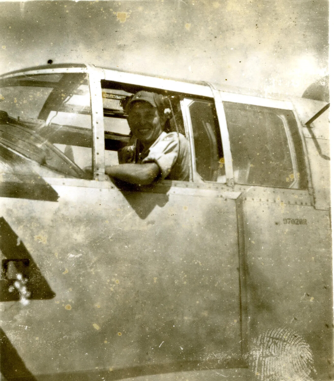 Aircrew Member Smiling from B-25 Mitchell Cockpit Window