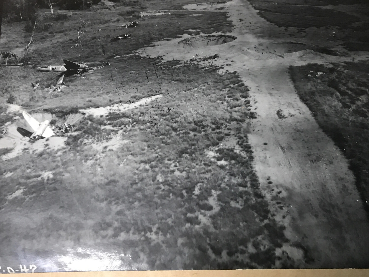 Aerial View of Bomb-Damaged Airfield with Wrecked Aircraft, Pacific Theater, WWII