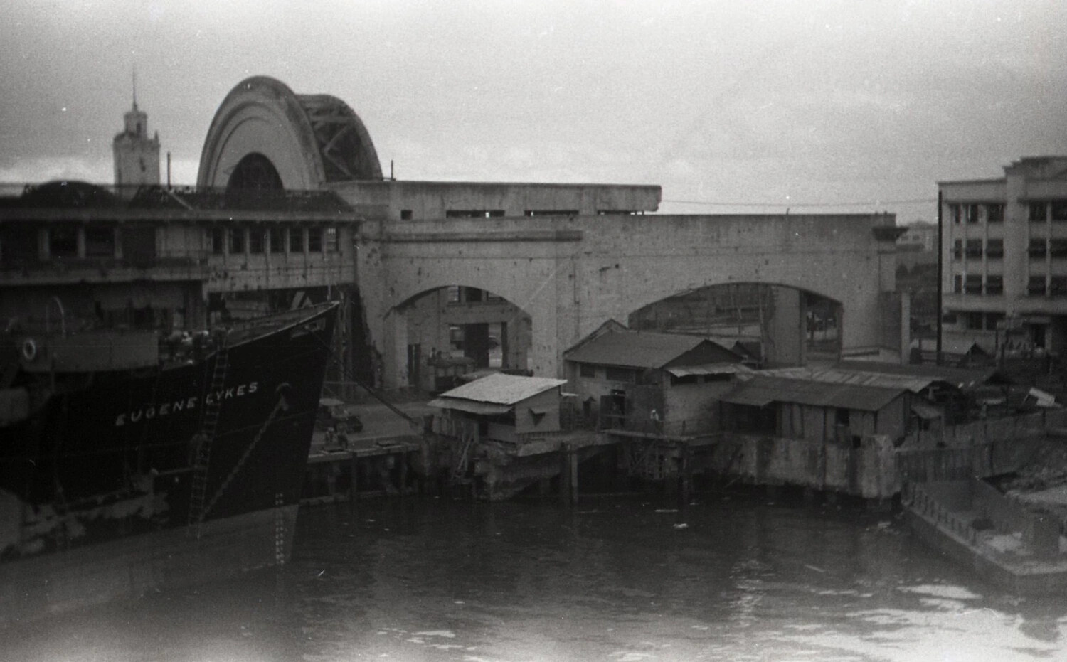 Cargo Ship EUGENE LYKES Moored Amid War-Damaged Manila Waterfront Structures, Philippines, 1945