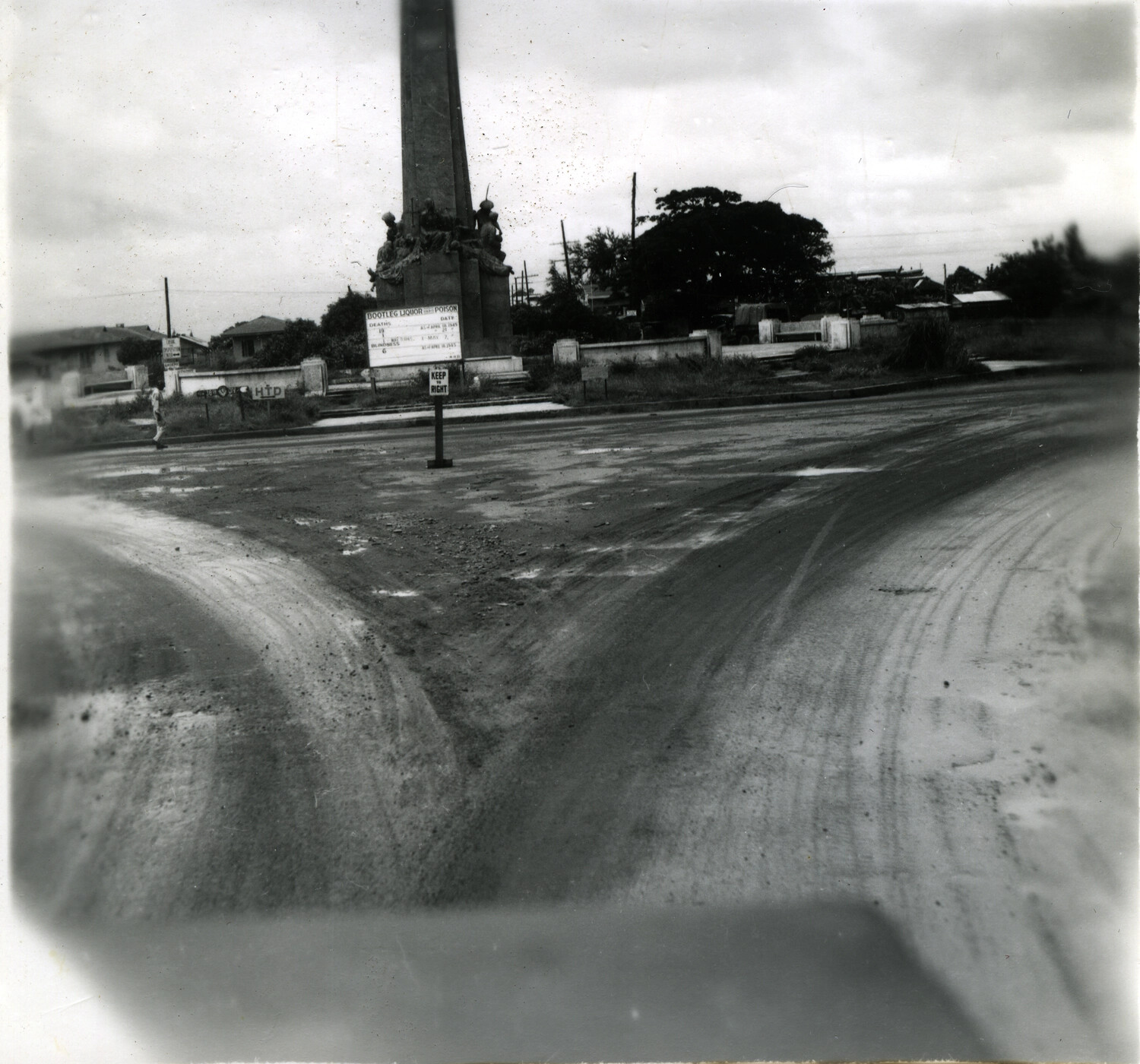 Post-Battle Occupation Scene with Monument and 'Bootleg Liquor' Warning Sign