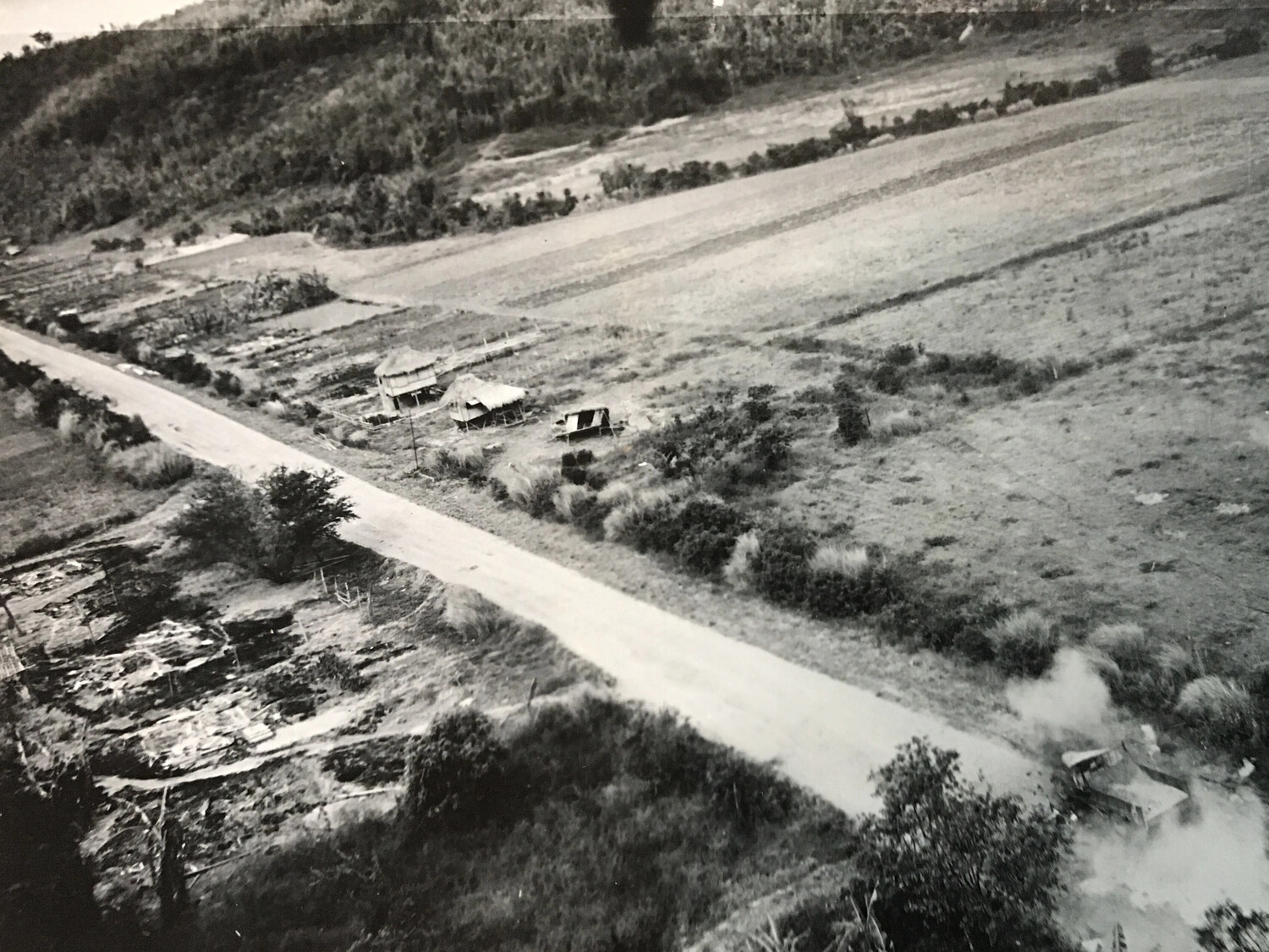 Aerial Photograph of Rural Valley with Farm Structures and Smoke, Philippines - 312th Bomb Group