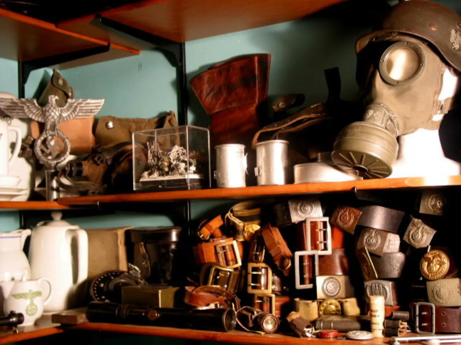 Close-Up Shelf Detail: German Eagle Emblem, Gas Mask, Canteens, and Leather Equipment