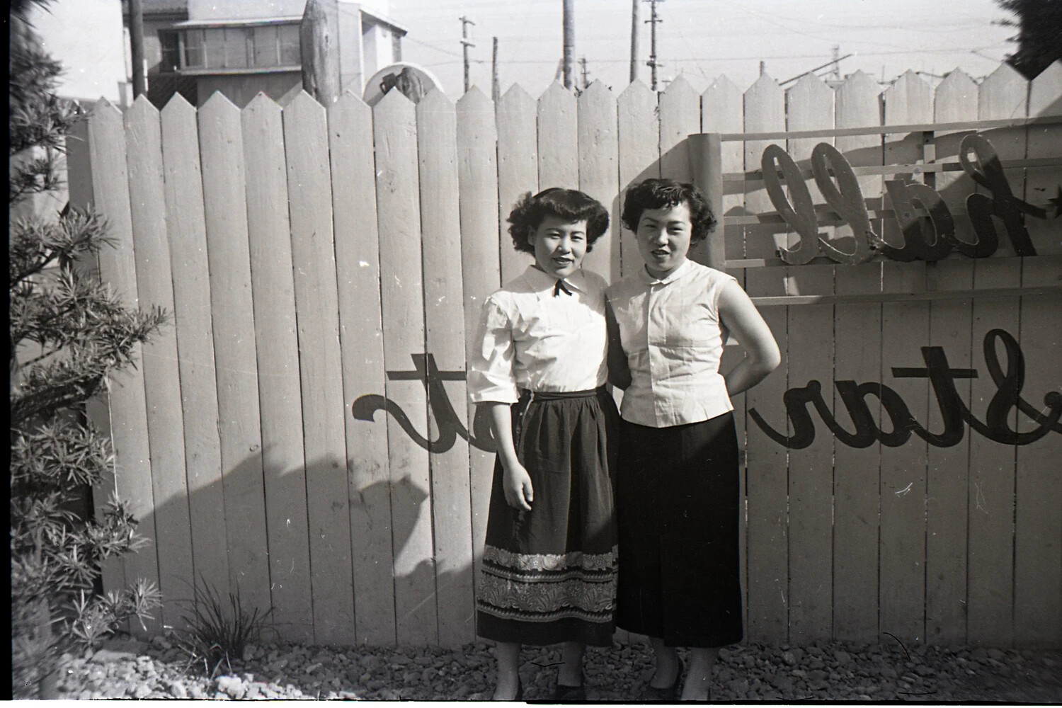 Two Young Women by a Painted Fence, Japan, Korean War Era