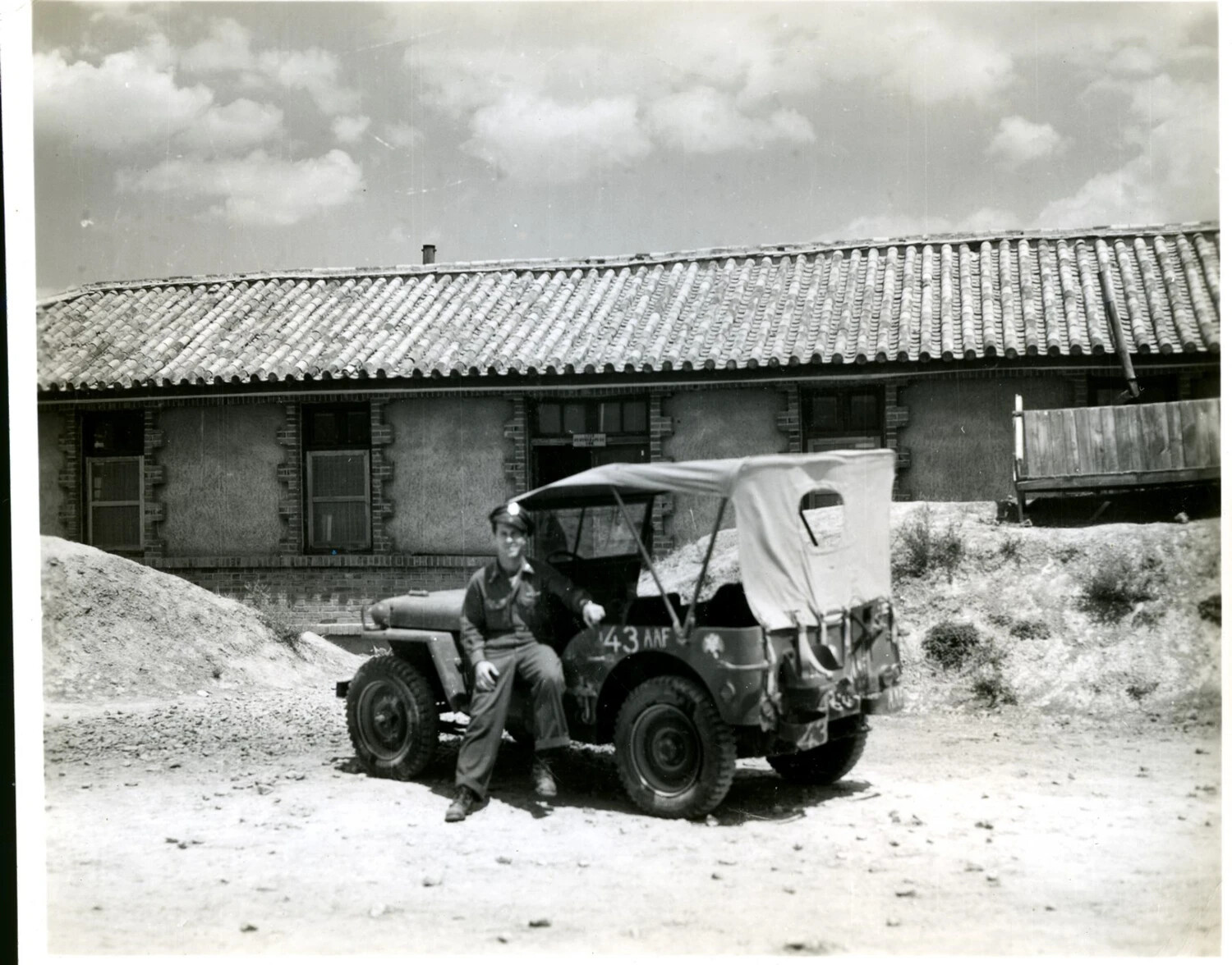 American Airman with Jeep Marked '43 AAF' Outside Tile-Roofed Building, CBI Theater, World War II
