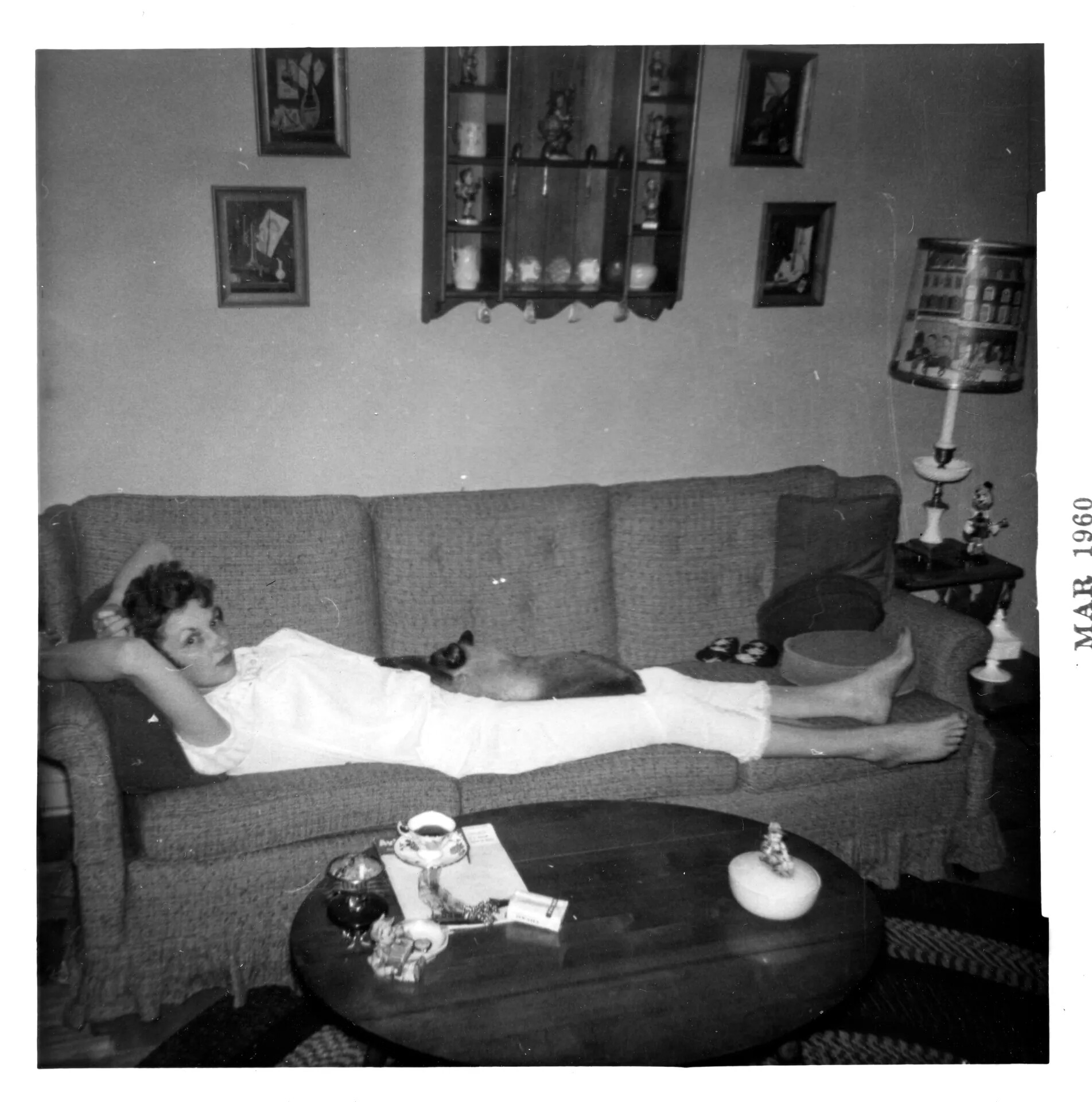 Woman Reclining on Sofa with Siamese Cat, Mel Swanson Family Album, March 1960