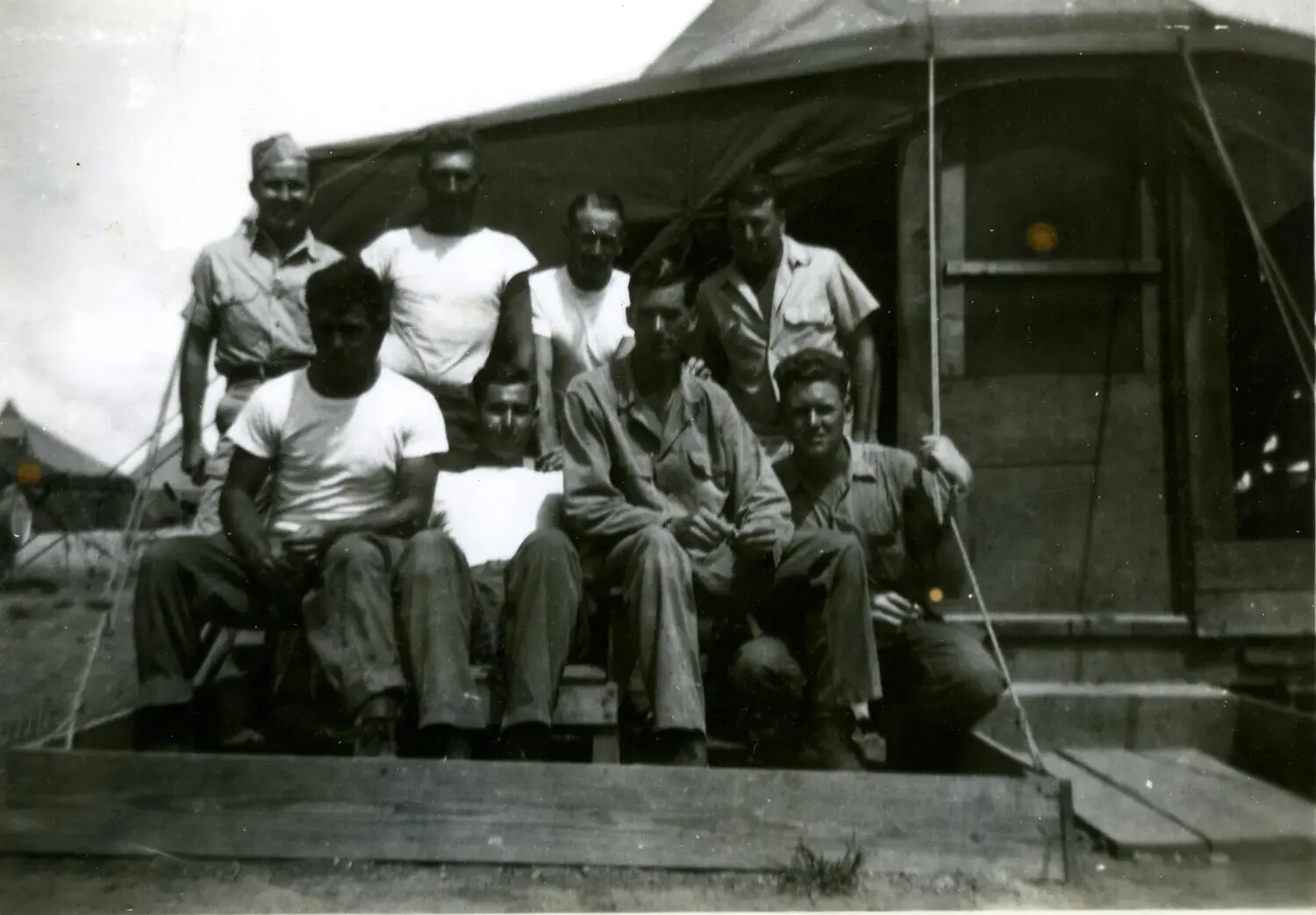 Nine U.S. Marines on Tent Platform Deck, 5th Marine Division Camp, Pacific Theater, 1945