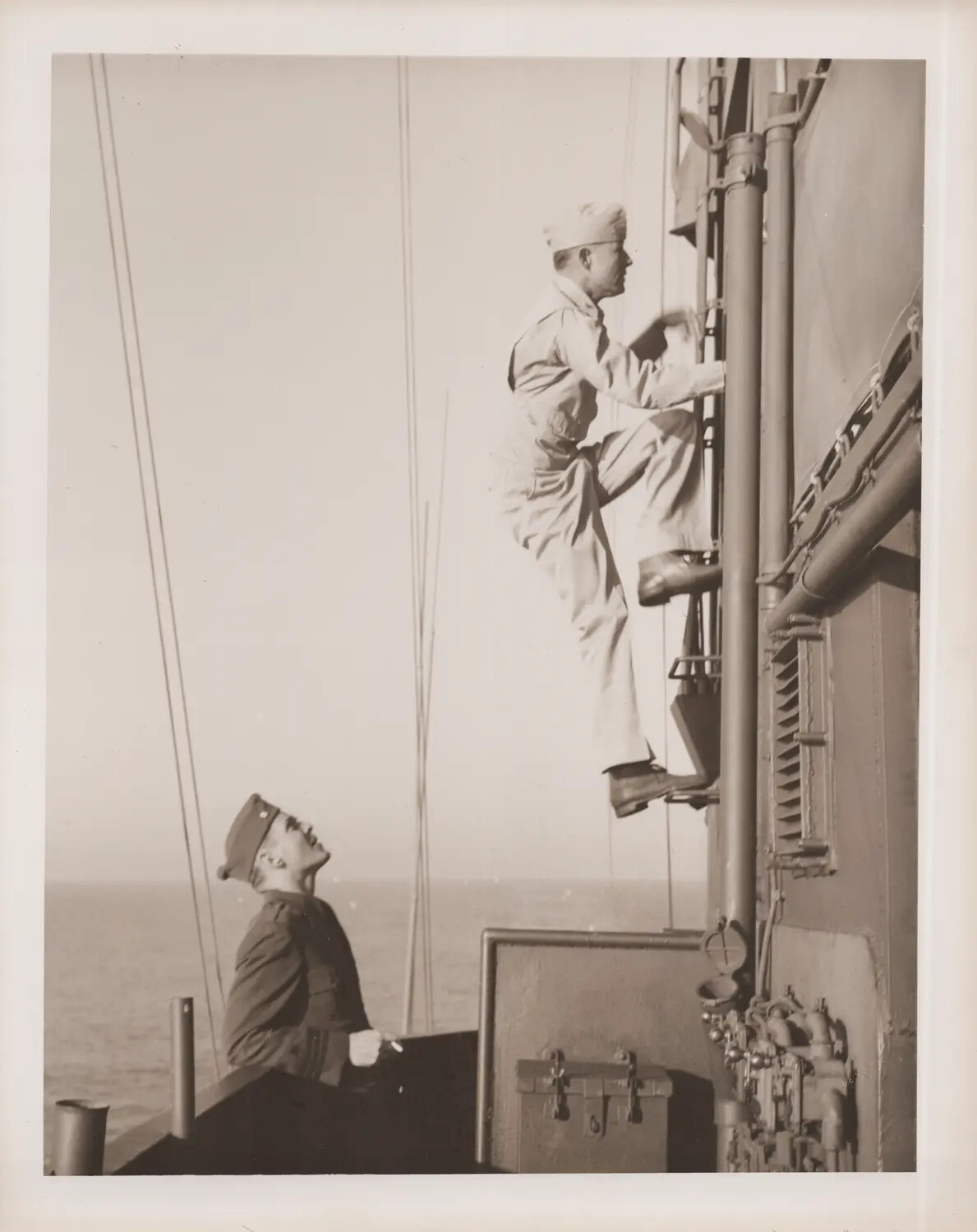 Sailor Climbing Superstructure Ladder Aboard Ship at Sea, WWII Era