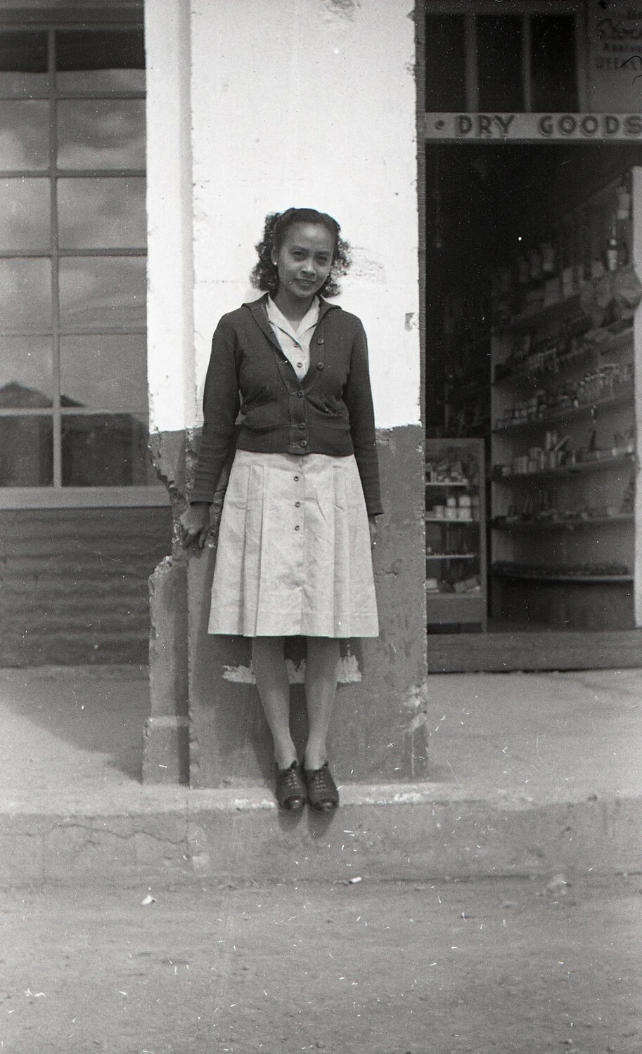 Portrait of a Young Woman Outside a Dry Goods Store, Luzon, Philippines, WWII Era