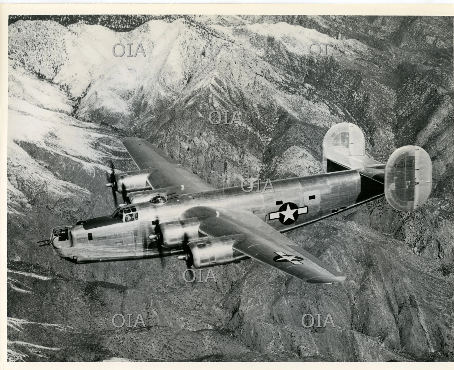 Consolidated B-24 Liberator Heavy Bomber in Flight Over Mountainous Terrain