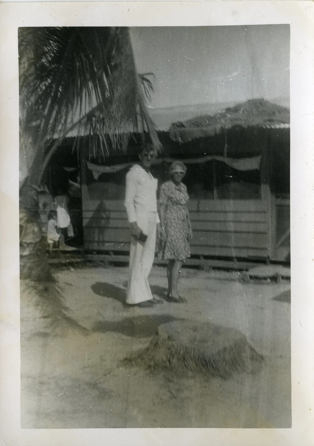 Man and Woman Posing Outside a Thatched-Roof Building, Manila, Philippines