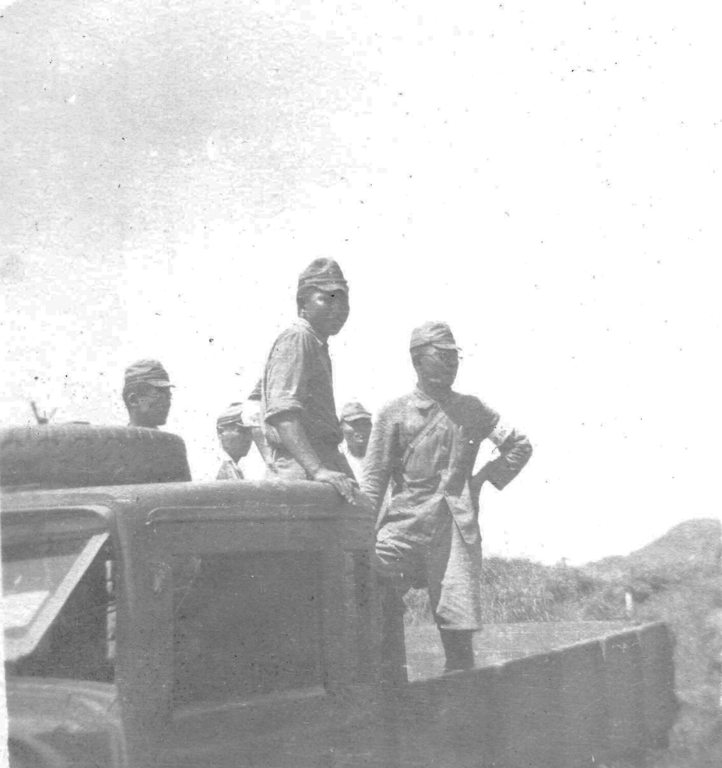 Japanese Men Riding in Truck Bed, Likely POWs or Laborers, Ie Shima/Okinawa Area