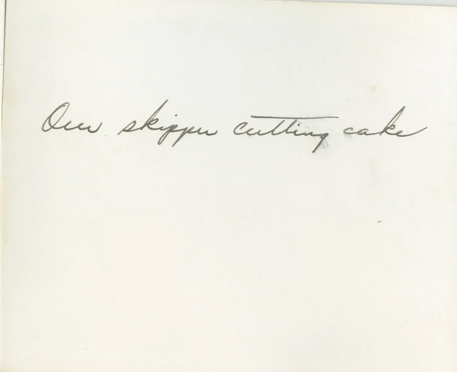 Handwritten Album Caption: 'Our Skipper Cutting Cake' (USS Petrof Bay CVE-80 Album)