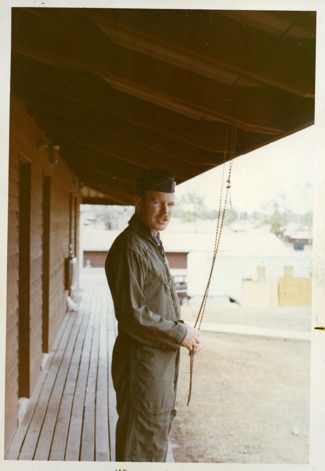 USAF Airman in Flight Suit on Barracks Porch, Nakhon Phanom RTAFB (NKP), Thailand, Vietnam War Era