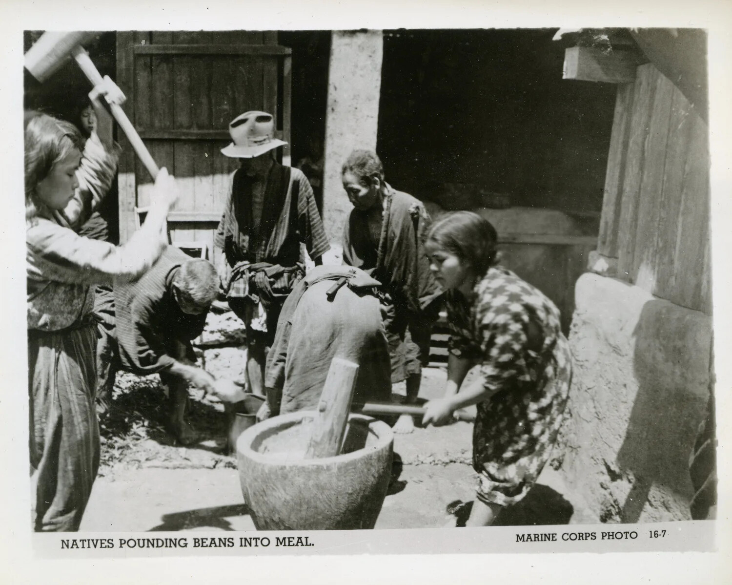 Okinawan Civilians Pounding Beans into Meal, Marine Corps Photo 16-7
