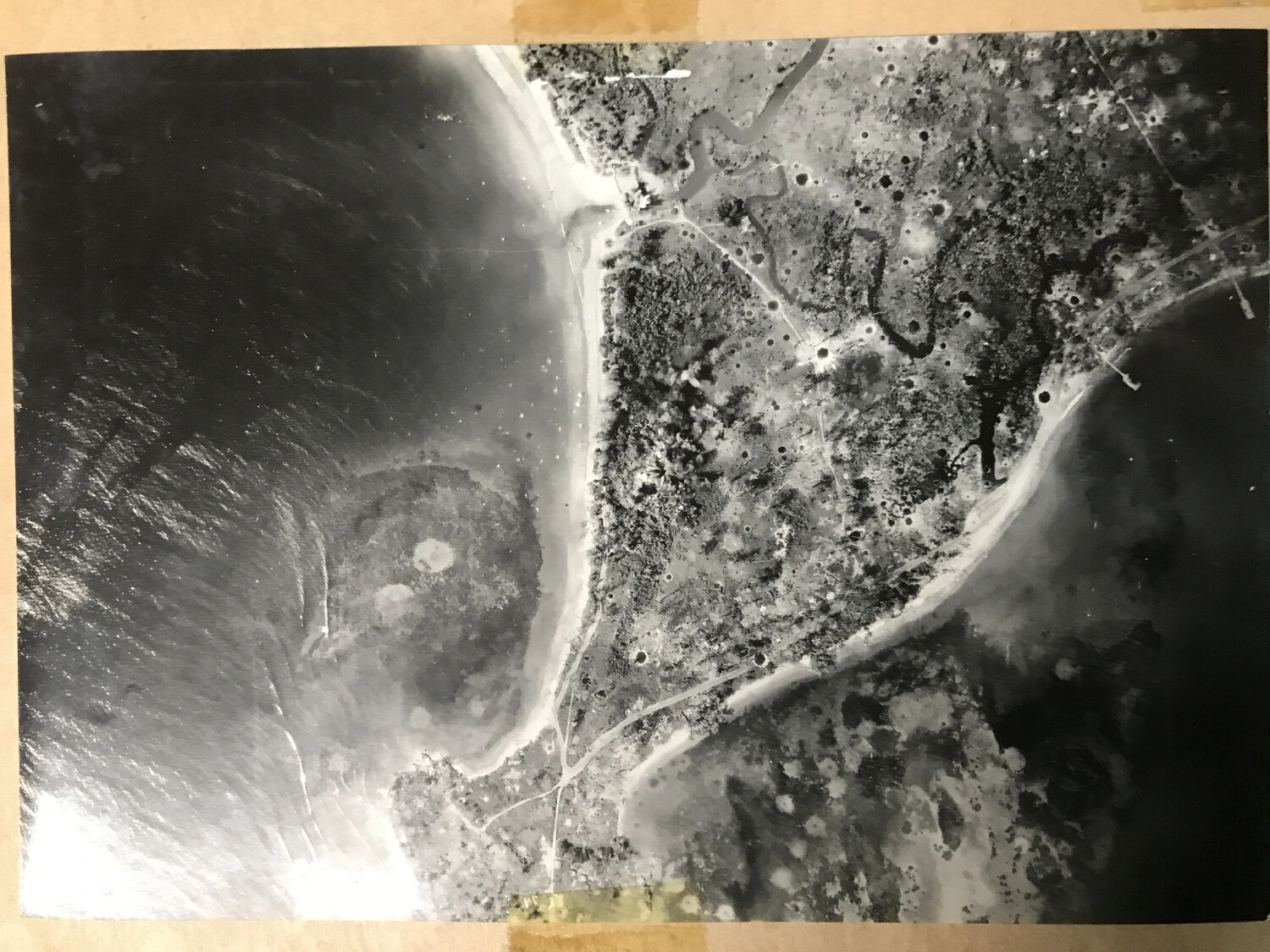 Album-Mounted Vertical Aerial Photograph of Bomb-Cratered Coastal Target