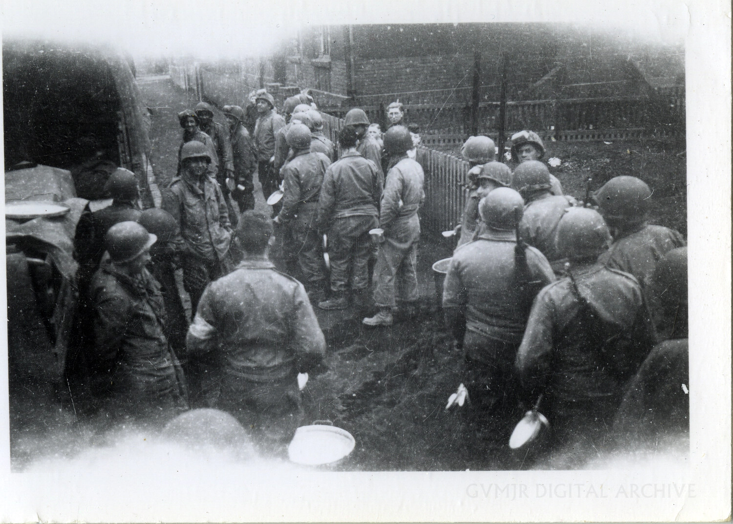 Soldiers Queuing for a Field Meal in a Village Alley