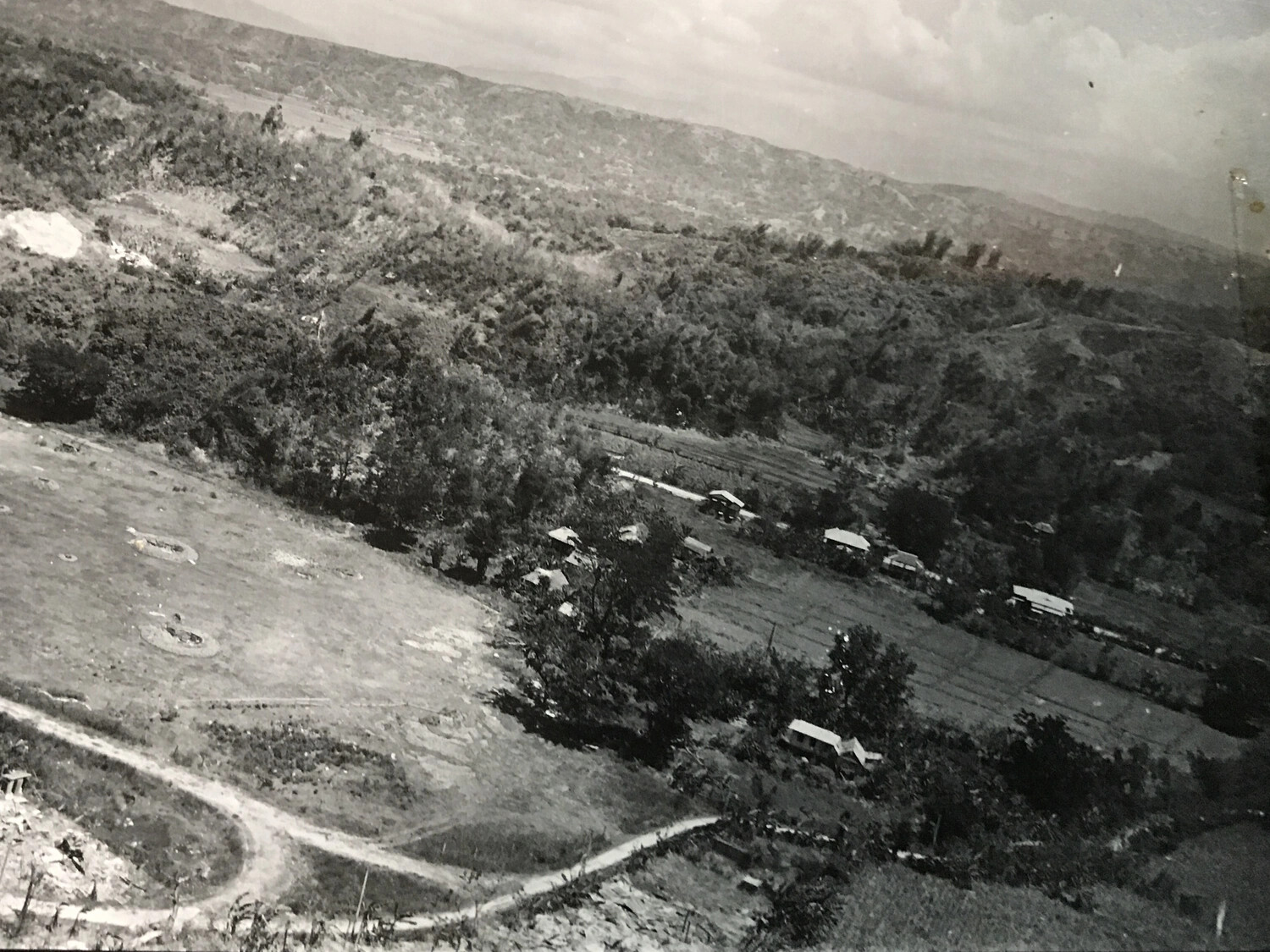 Aerial Reconnaissance View of Rural Valley with Circular Earthworks