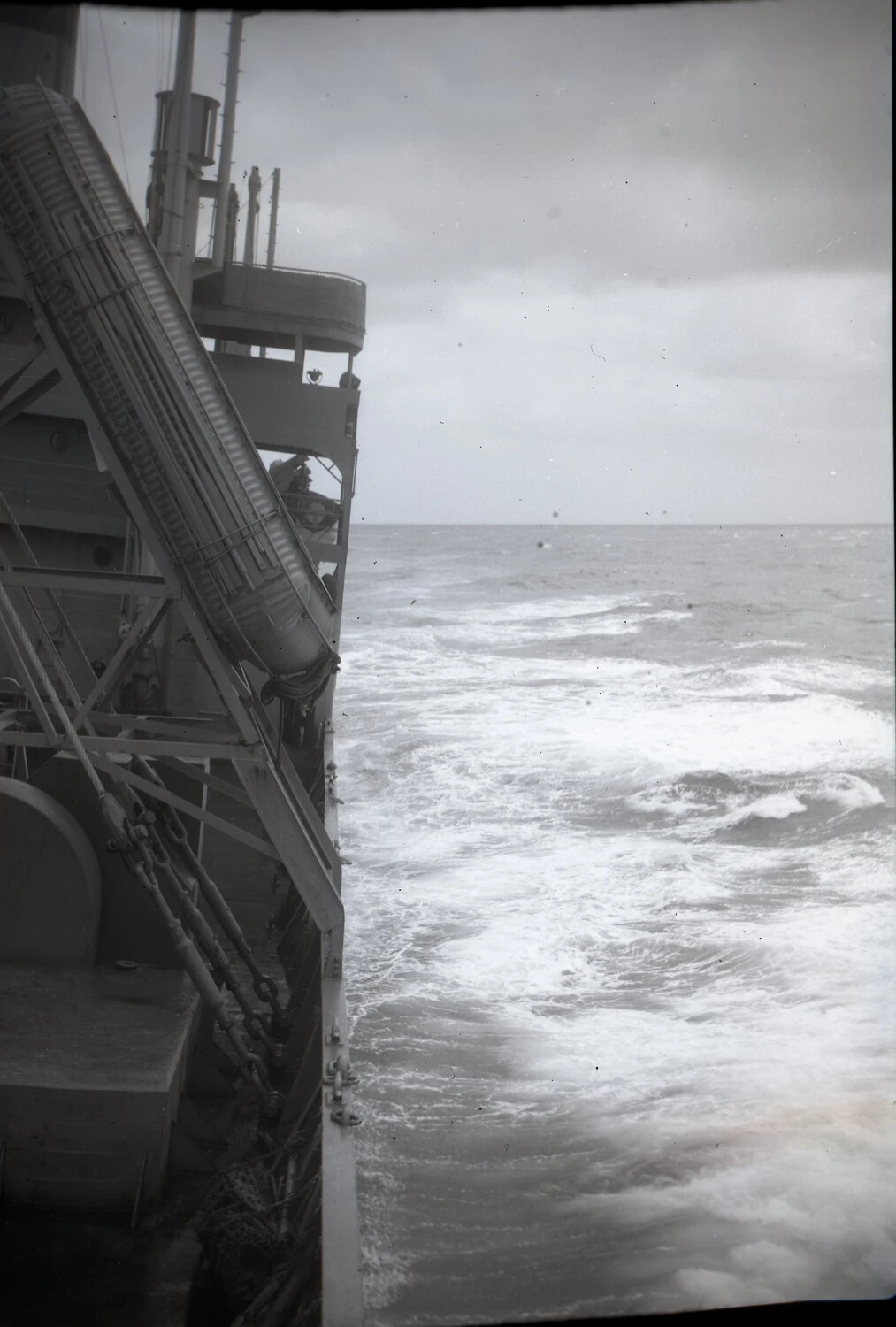 Warship Underway in Heavy Seas, Bow View with Covered Gun Barrel