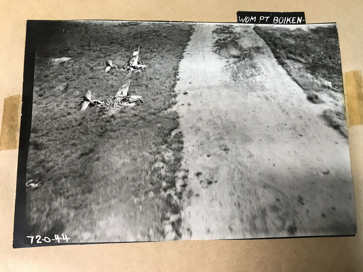 Two Destroyed Japanese Aircraft in Grass Beside Taxiway, Wom Point, Boiken, New Guinea (Print No. 72-0-44)