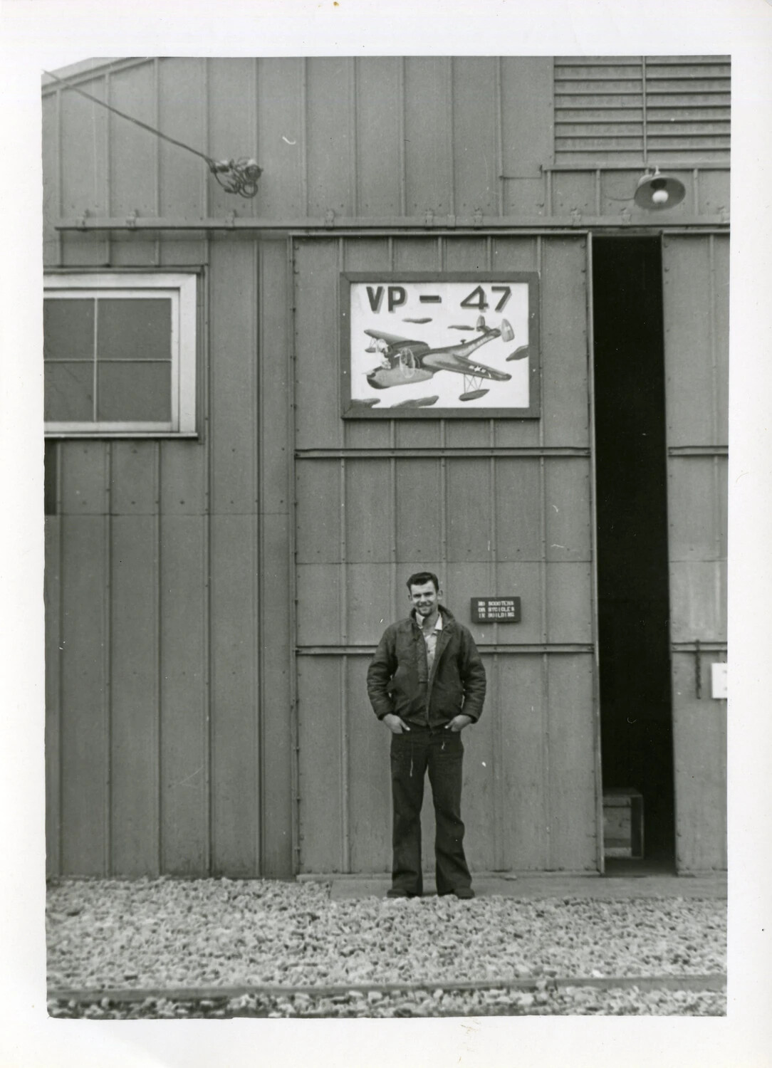 Sailor in Front of VP-47 Squadron Hangar Sign, Joseph Smith Collection