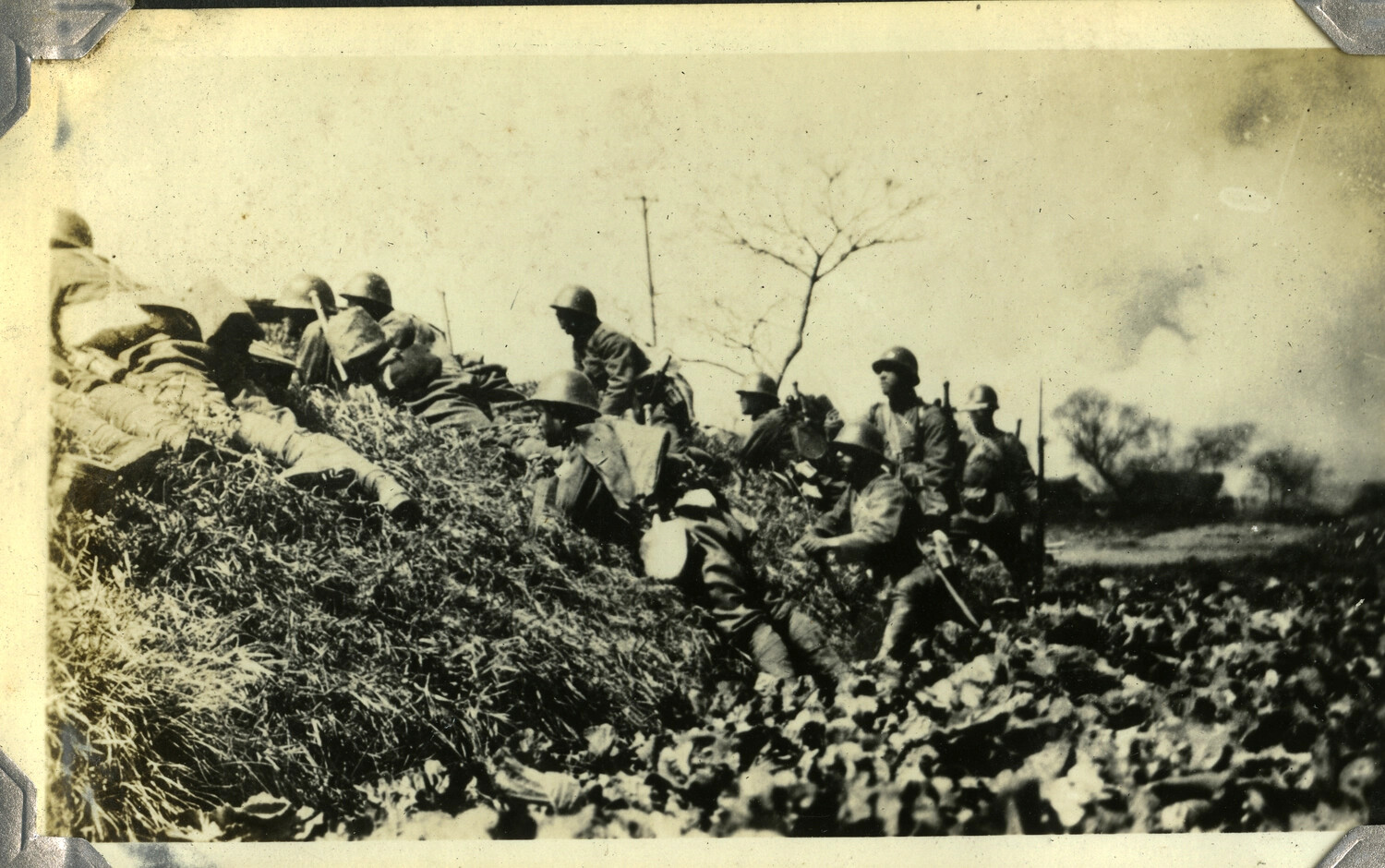 Soldiers with Fixed Bayonets Advancing Along a Ridge — Photograph from a Manila Photo Album