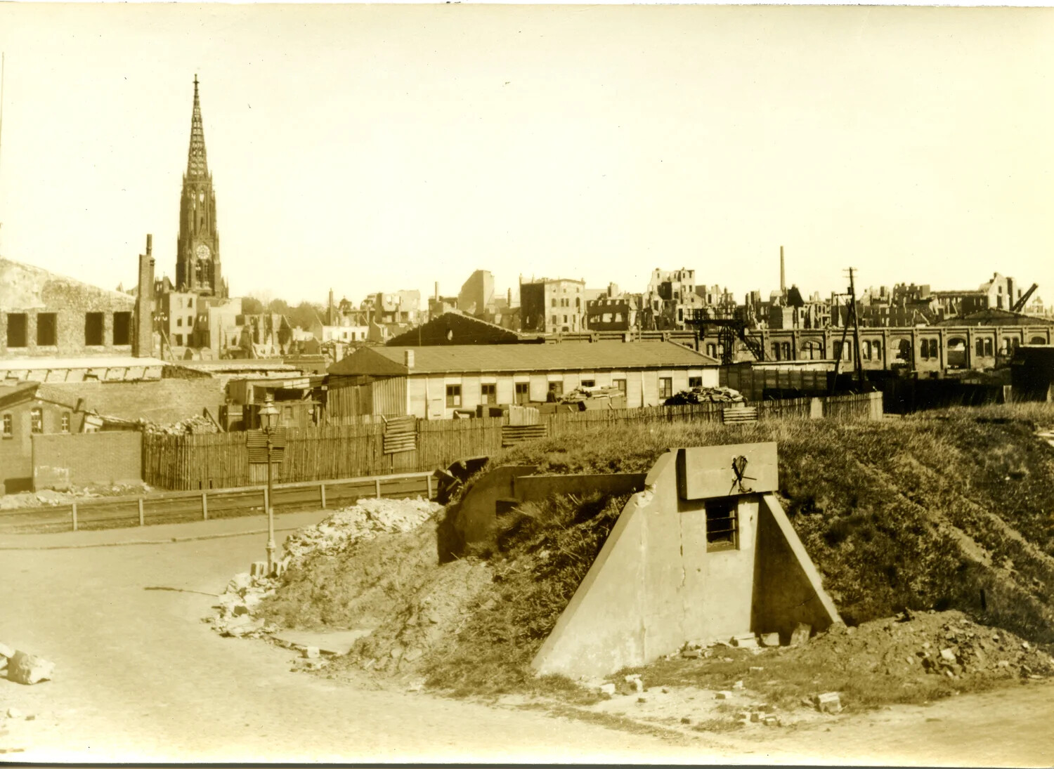 Bomb-Damaged German Cityscape with Concrete Bunker and Surviving Church Spire, WWII