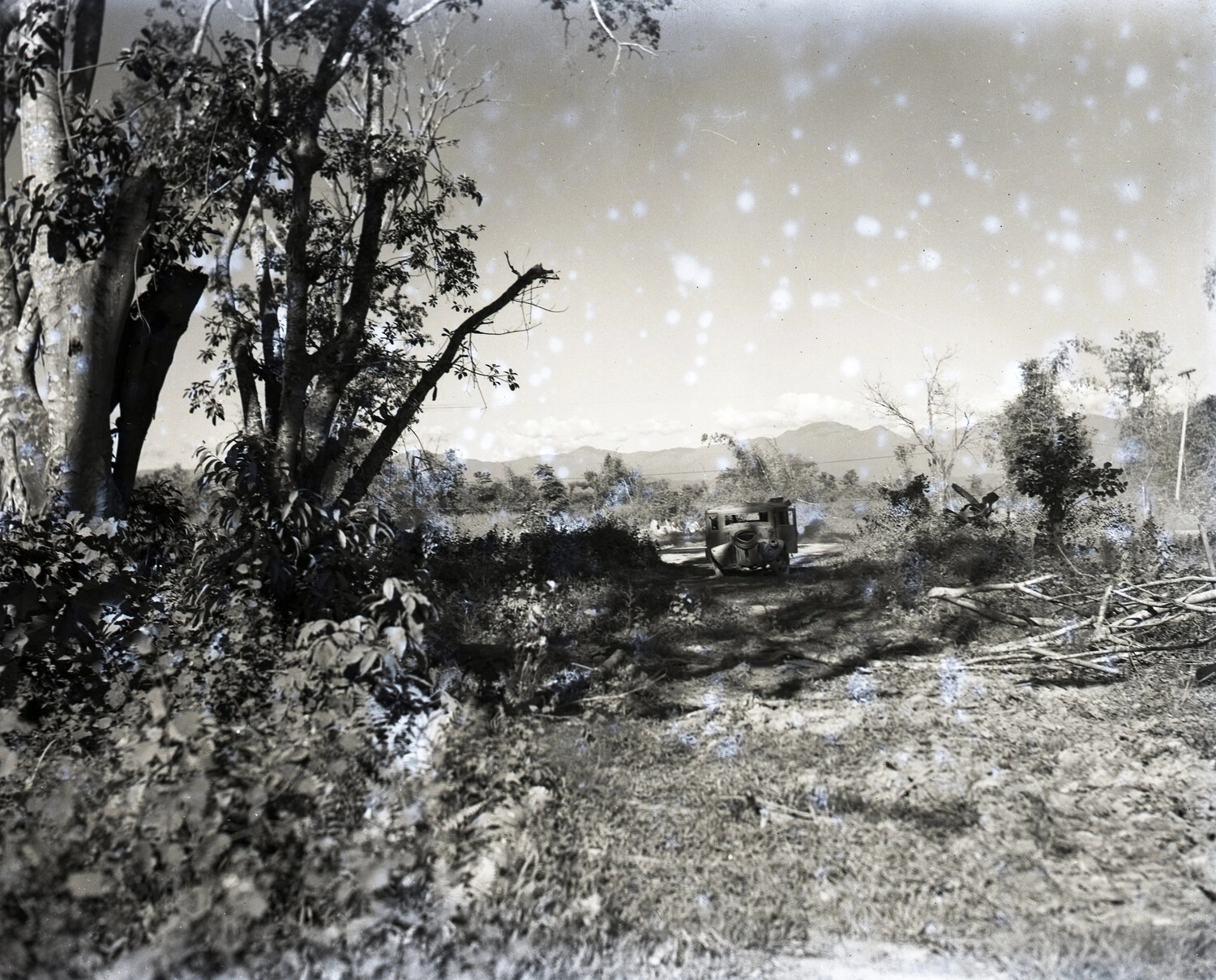 Abandoned Vehicle Wreck in Rural Burma Landscape, WWII China-Burma-India Theater