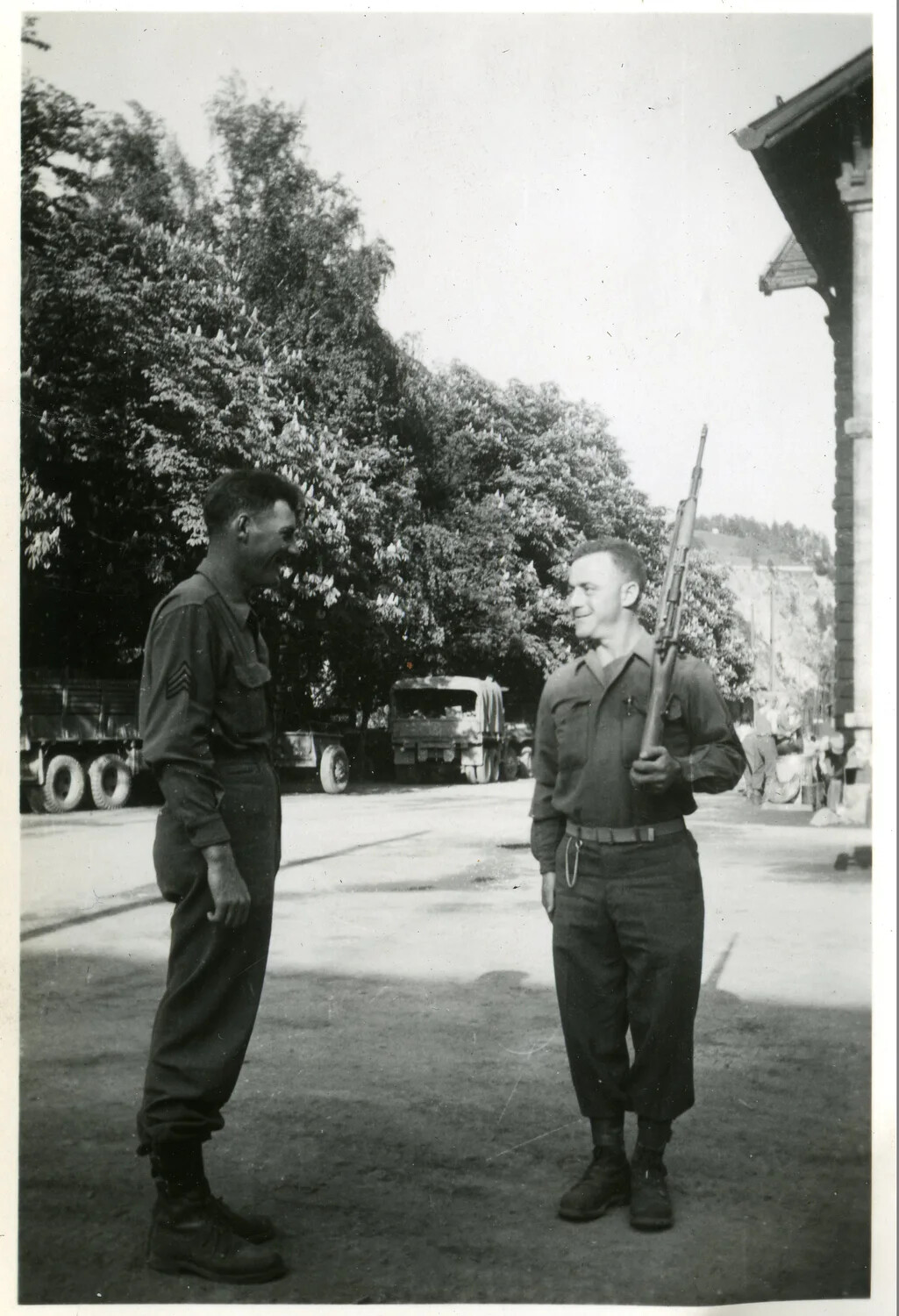 Two GIs of the 44th Infantry Division Sharing a Laugh in a European Town, WWII