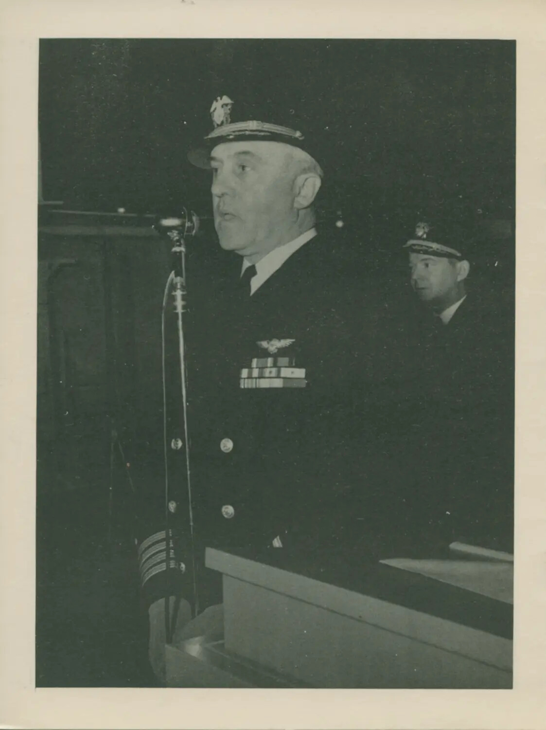 U.S. Navy Officer Addressing Assembly at Podium, USS Petrof Bay (CVE-80) Collection