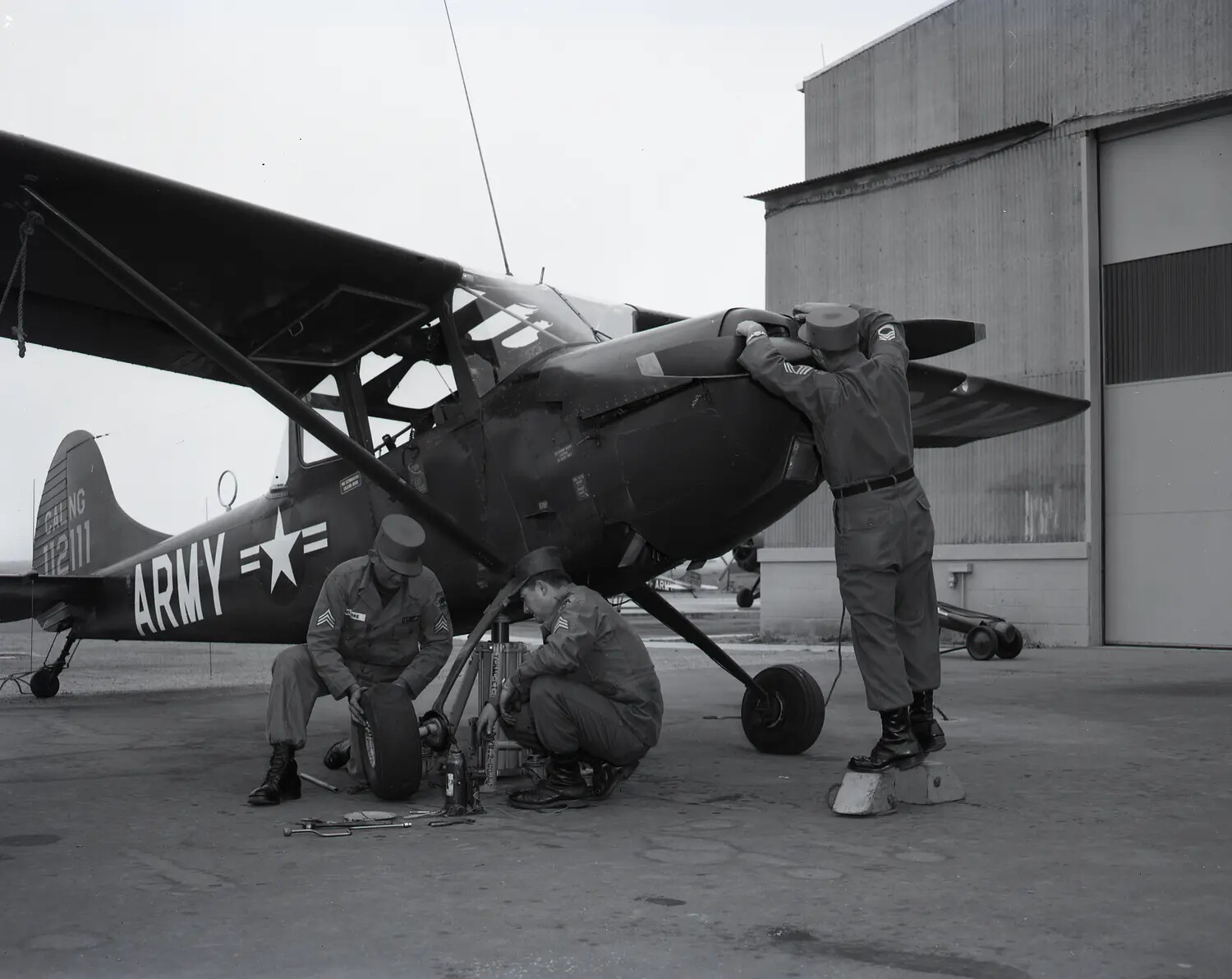 California Army National Guard Ground Crew Servicing a Cessna O-1 Bird Dog Liaison Aircraft