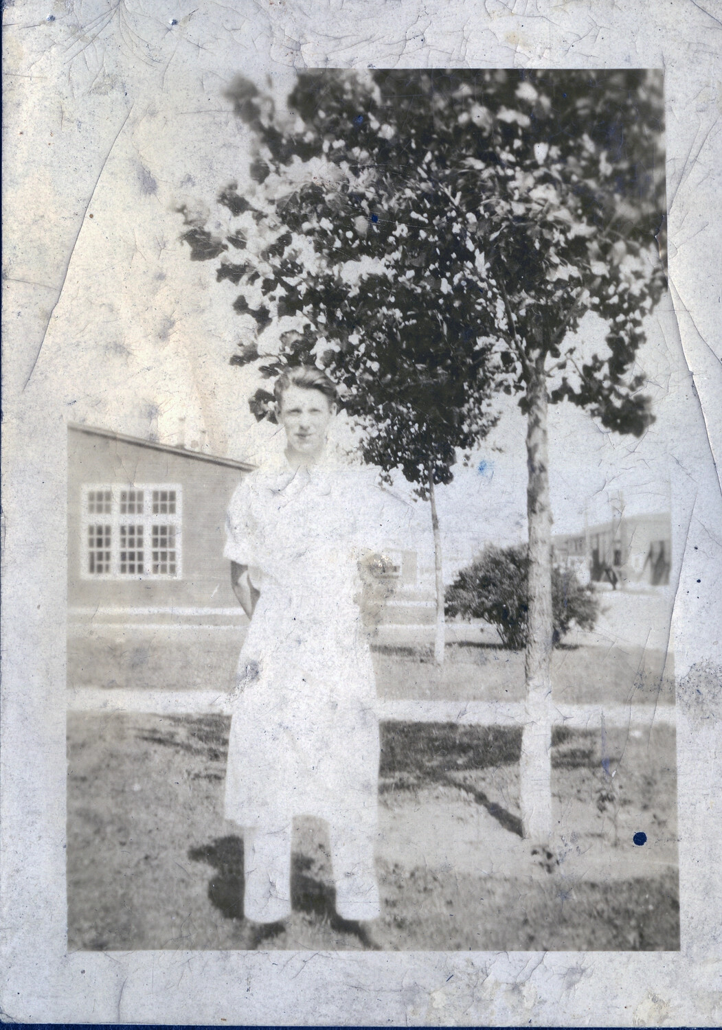 Man in White Uniform Beside Young Tree, Manila Area, Philippines, c. 1930s (Damaged Print)
